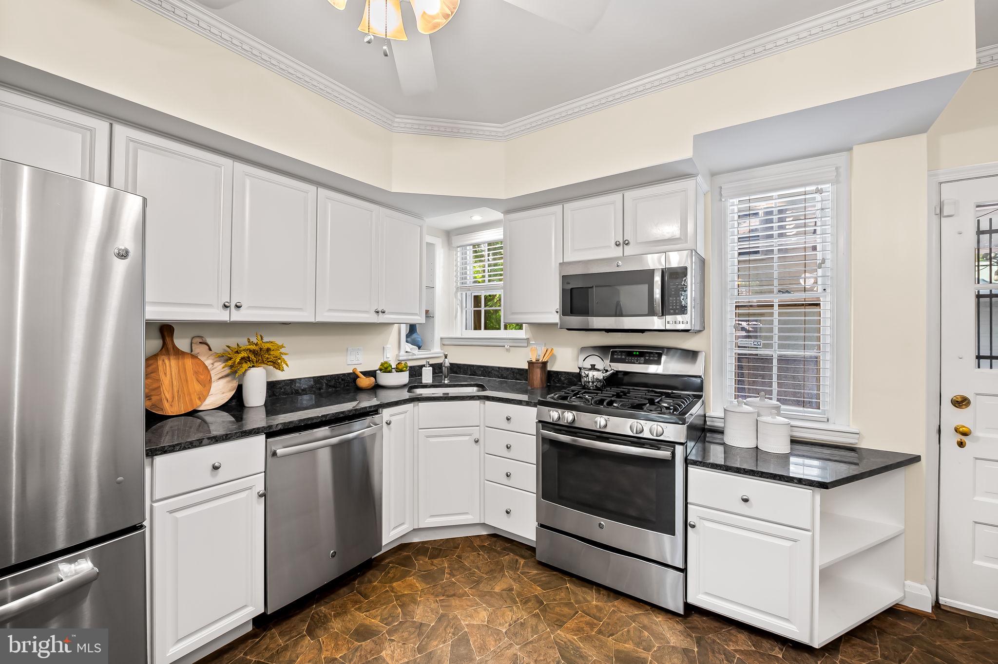 349 Tunbridge Road Baltimore, MD 21212 - Photo 17 of 43 a kitchen with white cabinets stainless steel appliances and sink
