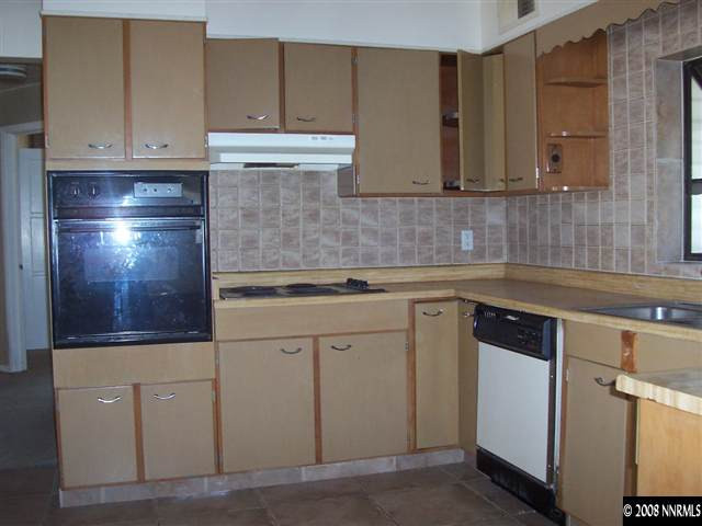 174 South Maddux Drive Reno, NV 89512 - Photo 3 of 8 a kitchen with stainless steel appliances granite countertop a sink and cabinets