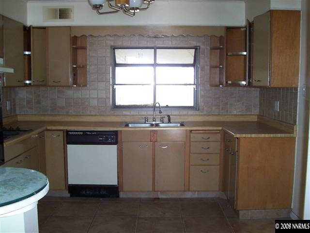 174 South Maddux Drive Reno, NV 89512 - Photo 4 of 8 a kitchen with a sink stove and cabinets