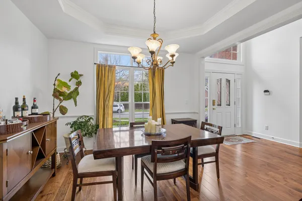 a view of a dining room with furniture wooden floor and a chandelier