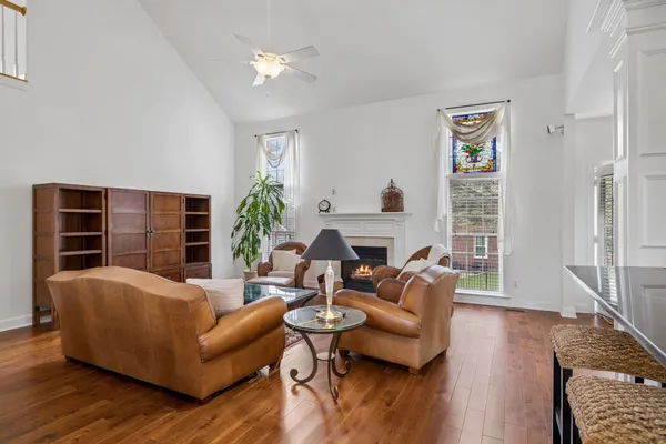 a living room with furniture a fireplace and a flat screen tv