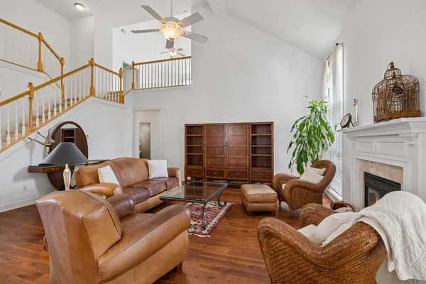 a living room with furniture ceiling fan and a rug
