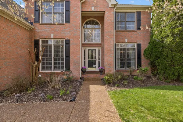 a front view of a house with garden