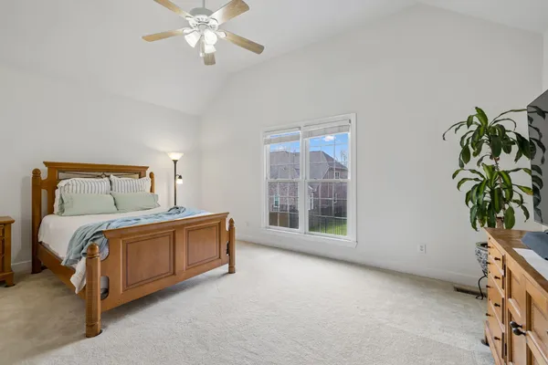a bed sitting in a room next to a window
