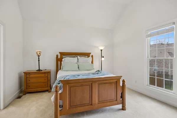 a bedroom with a bed and a table