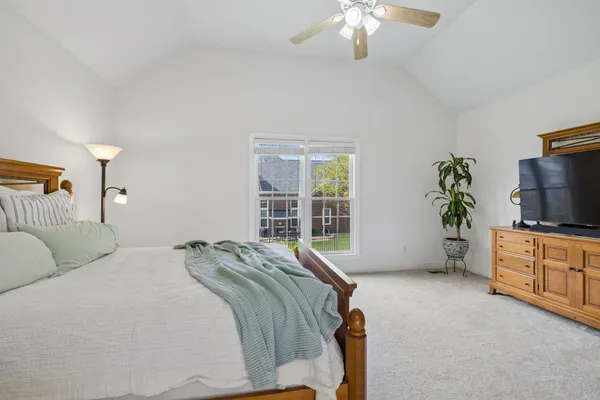 a bedroom with a bed and a television