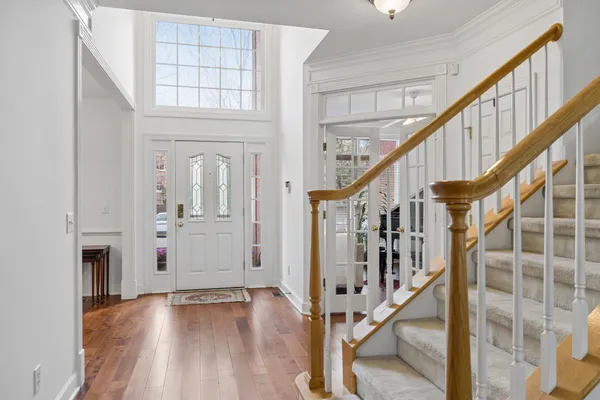 a view of entryway with wooden floor and stairs