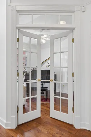 a view of a livingroom with wooden floor and staircase