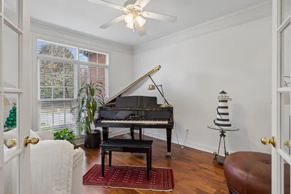 a living room with furniture a window and a potted plant