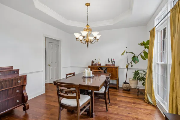 a view of a dining room with furniture and wooden floor