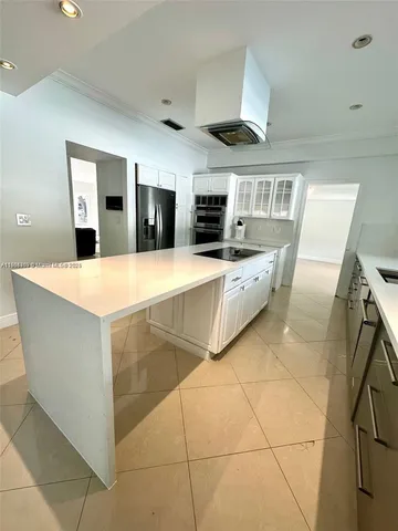 a kitchen with stainless steel appliances granite countertop a sink and a stove top oven