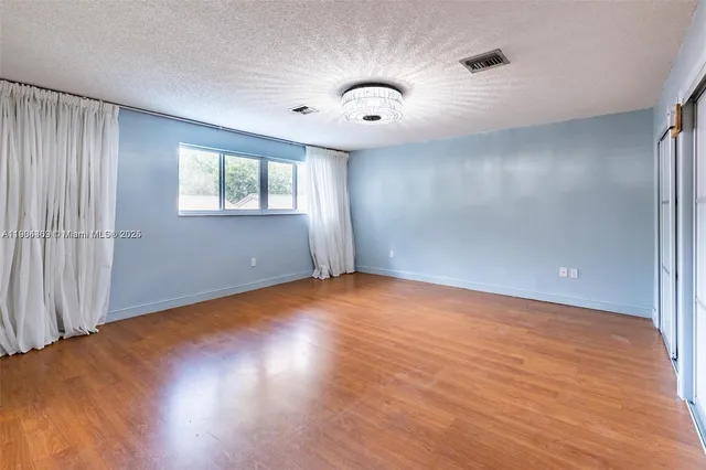 a view of an entryway with wooden floor