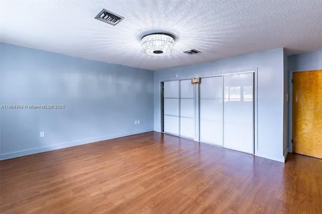 a view of a dining room with furniture and a window