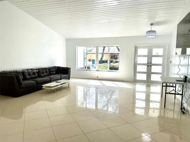 a living room with a large window and a table