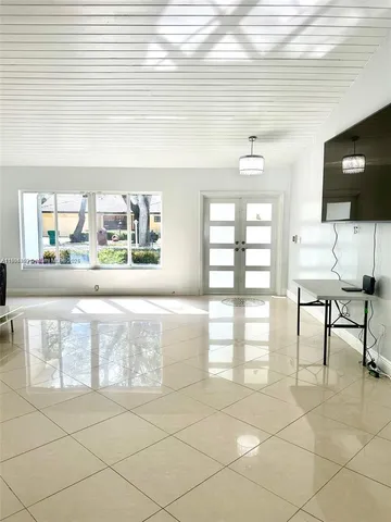 a large white kitchen with a large window
