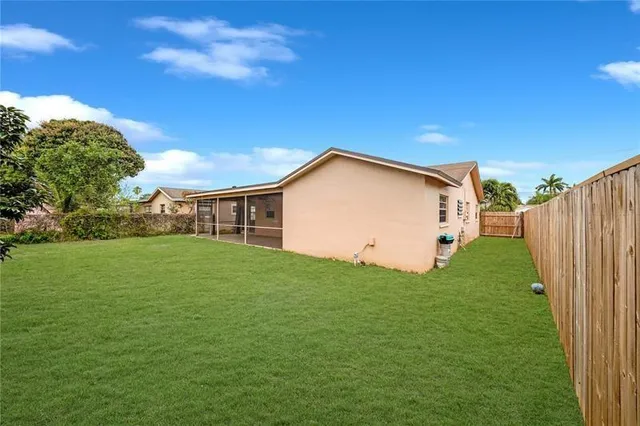 a view of a backyard with barn plants and large trees