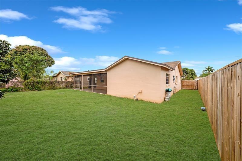 9728 Southwest 3rd Street Boca Raton, FL 33428 - Photo 7 of 7 a view of a backyard with barn plants and large trees