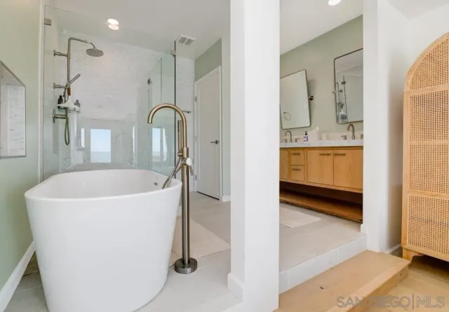 a bathroom with a double vanity sink and mirror