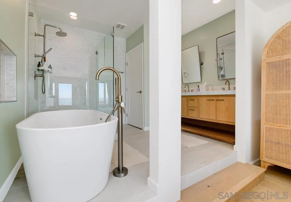 2633 Ocean Street Carlsbad, CA 92008 - Photo 17 of 23 a spacious bathroom with a tub sink and mirror