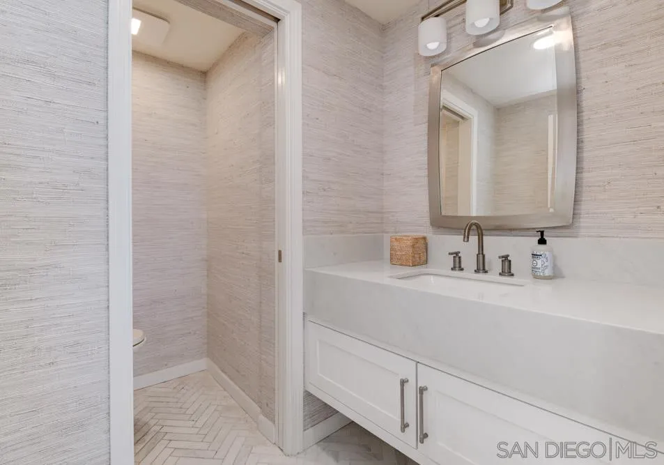 2633 Ocean Street Carlsbad, CA 92008 - Photo 19 of 23 a bathroom with a sink and a mirror