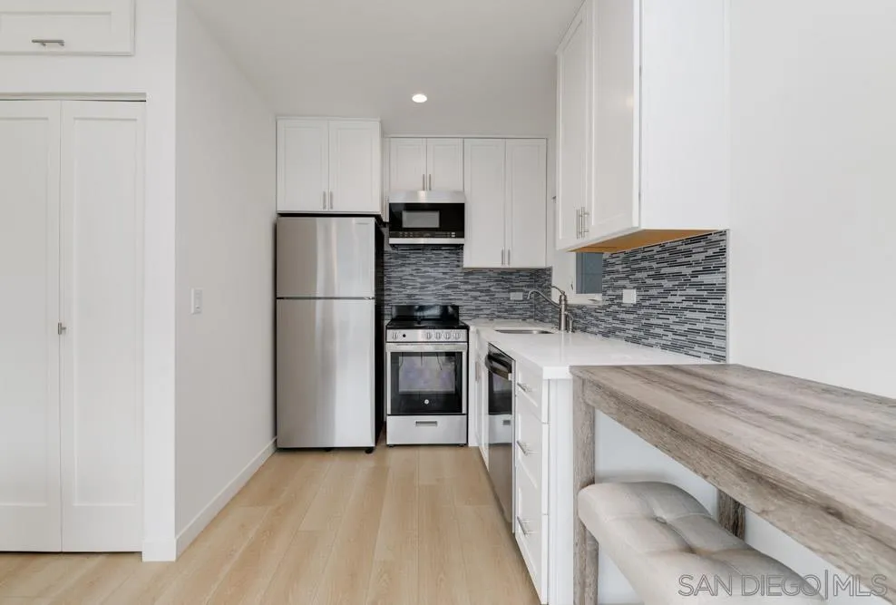 2633 Ocean Street Carlsbad, CA 92008 - Photo 6 of 23 a kitchen with cabinets and stainless steel appliances