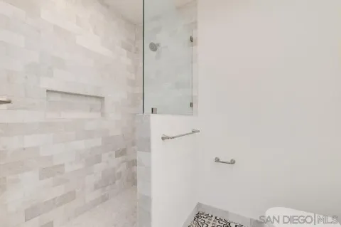 a kitchen with granite countertop white cabinets and stainless steel appliances