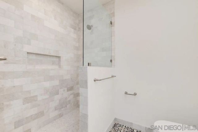 a kitchen with granite countertop white cabinets and stainless steel appliances