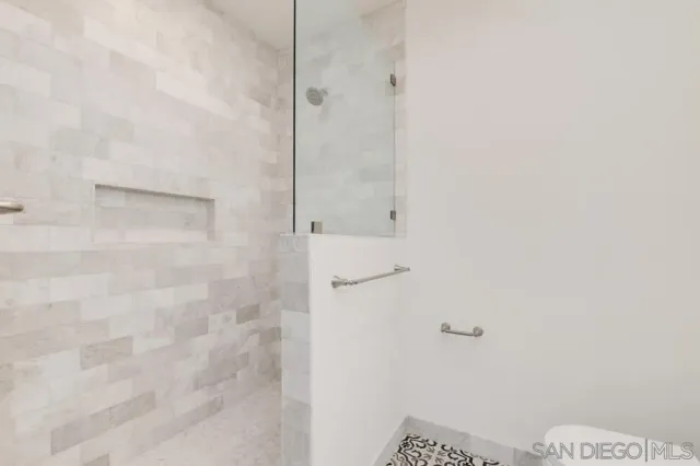 a kitchen with granite countertop white cabinets and stainless steel appliances