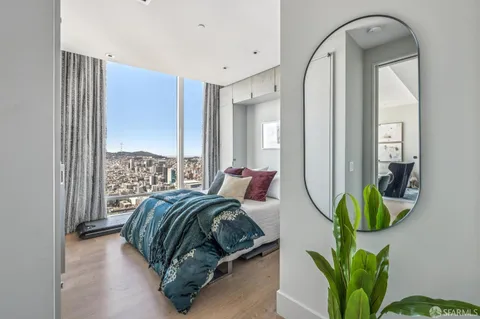 a bedroom with a bed and a painting on the wall