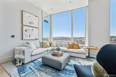 a living room with furniture and large windows
