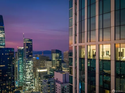 a living room with furniture and floor to ceiling windows