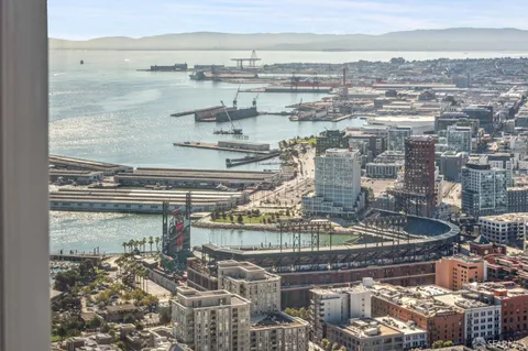 a view of a living room with a floor to ceiling window and outside view