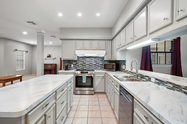 a kitchen with a sink stove and refrigerator