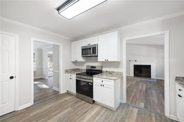 a kitchen with a stove top oven and cabinets