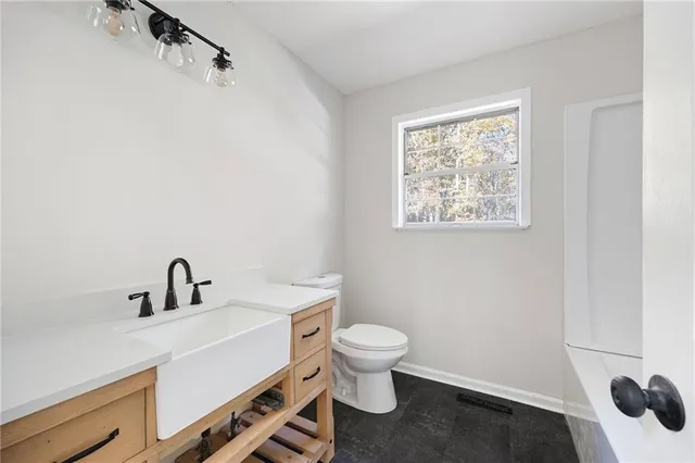 a bathroom with a sink toilet and vanity