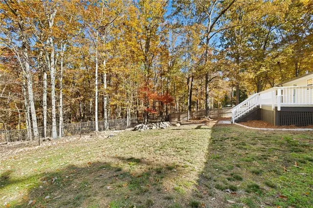a view of swimming pool with a yard and trees