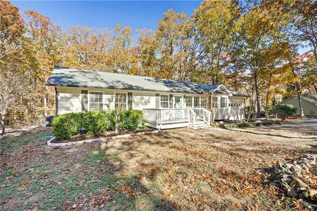 a view of a house with a yard and tree s