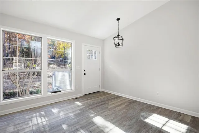 a view of a room with window and hardwood floor
