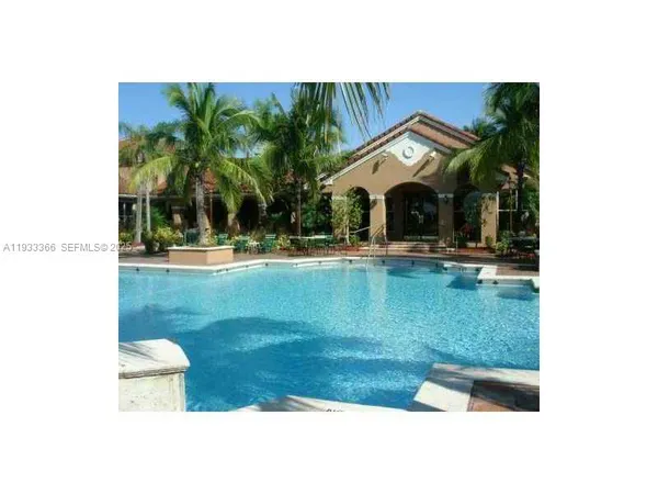 a view of swimming pool with a yard and seating space