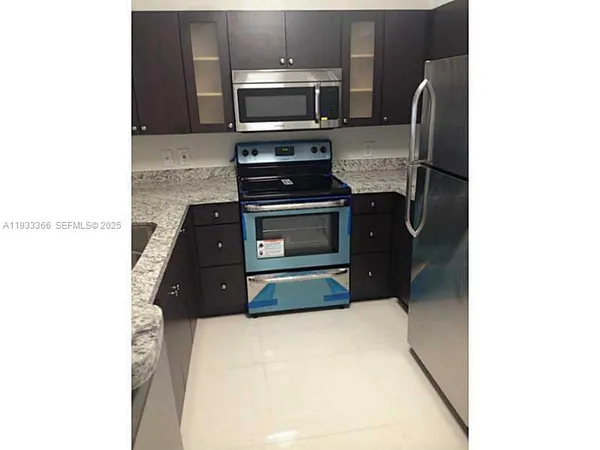 a kitchen with a refrigerator and a stove