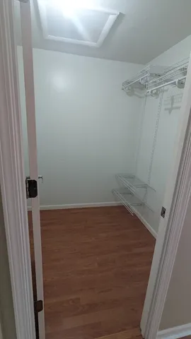 a spacious bedroom with a bed and window