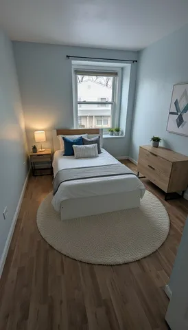 a utility room with wooden floor washer and dryer
