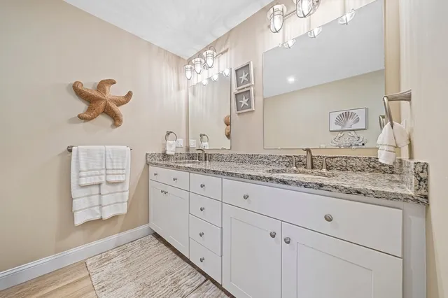 a bathroom with a granite countertop sink mirror and double