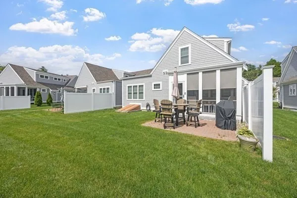 a front view of a house with garden and sitting area