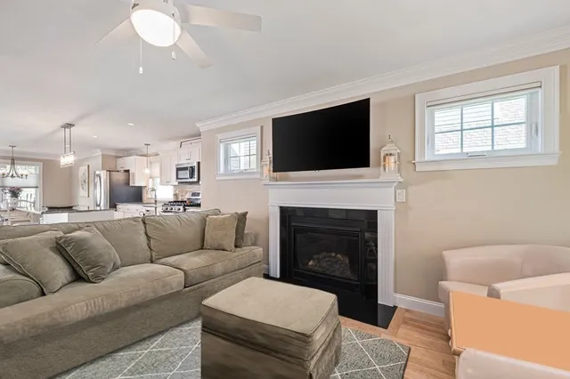 a living room with furniture a fireplace and a flat screen tv