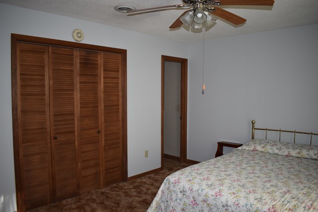 135 Taylor Road Gray, GA 31032 - Photo 14 of 28 a bedroom with a bed and a chandelier