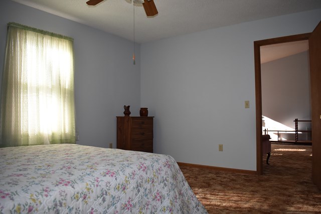 135 Taylor Road Gray, GA 31032 - Photo 15 of 28 a bedroom with a bed and wooden floor