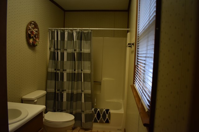 135 Taylor Road Gray, GA 31032 - Photo 16 of 28 a bathroom with a toilet and shower