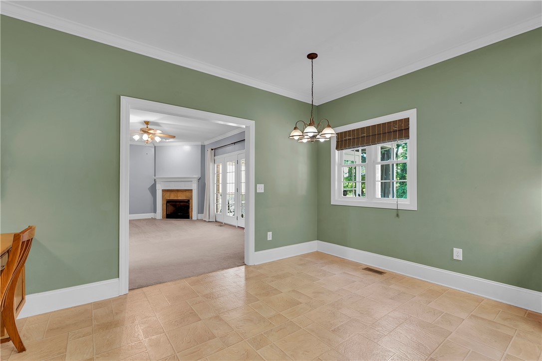 406 Hopewell Ridge Anderson, SC 29621 - Photo 12 of 46 This bright dining area features an open entry to a spacious living room with a fireplace.