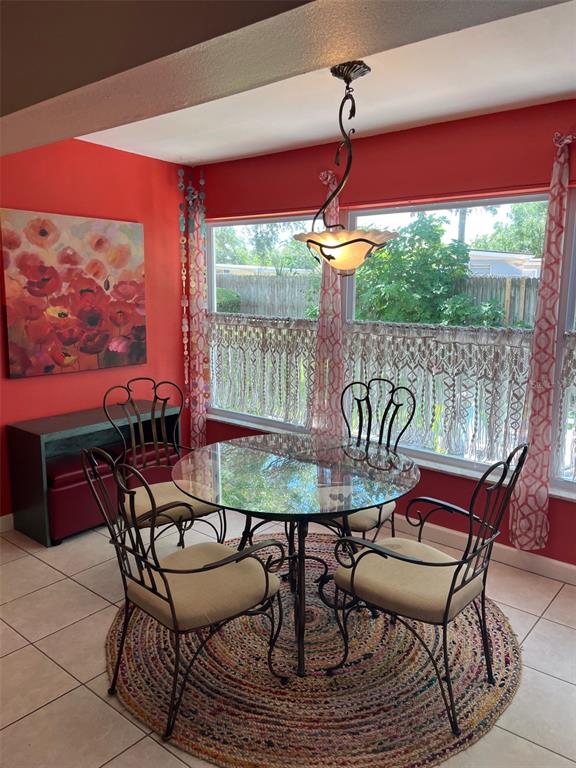 8372 Candlewood Road Seminole, FL 33777 - Photo 8 of 13 a view of a patio with a table chairs and a table